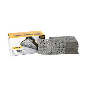 A box of Mirika Iridium 83 x 133 rectangular pads next to a stack of gray pads with multi-holes on a white background.